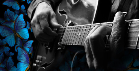 playing music blues. guitarist hands and guitar close up. playing electric guitar. blue morpho...