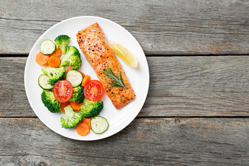 Baked salmon fillet with broccoli and vegetables mix.