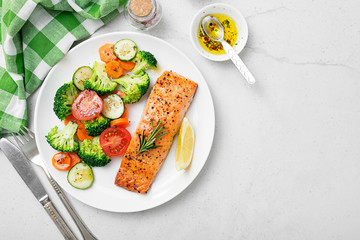 Baked salmon fillet with broccoli and vegetables mix.