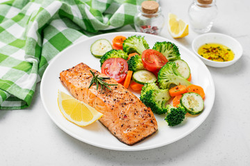 Baked salmon fillet with broccoli and vegetables mix.