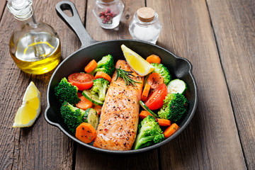 Baked salmon fillet with broccoli and vegetables mix.