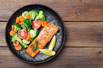 Baked salmon fillet with broccoli and vegetables mix.
