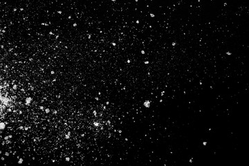 white crystalline powder on a black background. sugar dust 