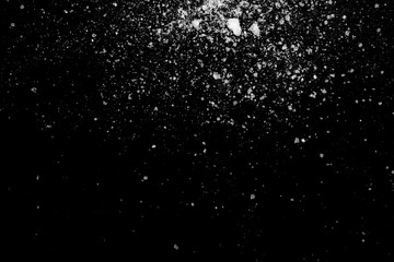 white crystalline powder on a black background. sugar dust 