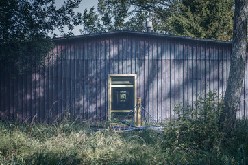 abandoned summer campsite violet building with yellow door frame