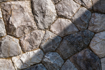 Close up big fragment of rock stone wall texture in two tone gray color for wallpaper, background or decoration printables.