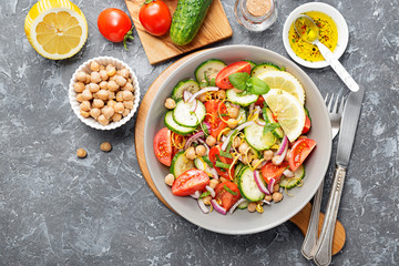 Salad of chickpeas, tomatoes, cucumbers and greens. Dietary food. Vegan salad.