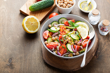 Salad of chickpeas, tomatoes, cucumbers and greens. Dietary food. Vegan salad.