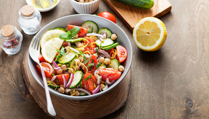 Salad of chickpeas, tomatoes, cucumbers and greens. Dietary food. Vegan salad.