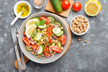 Salad of chickpeas, tomatoes, cucumbers and greens. Dietary food. Vegan salad.