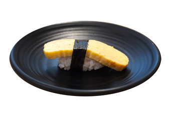 Tamagoyaki Sushi, Sweet omelette in a black ceramic plate isolated on white background.
