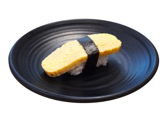 Tamagoyaki Sushi, Sweet omelette in a black ceramic plate isolated on white background.