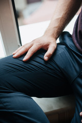 A man in a purple polo and posing for advertising men's clothing. Shooting for men's clothing store