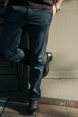 A man in a purple polo and posing for advertising men's clothing. Shooting for men's clothing store