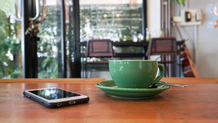 Smartphone with cup of coffee.