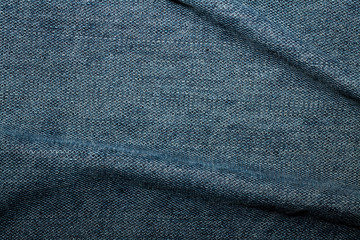 Blue denim texture with bends, background, abstraction. Textile space for text.