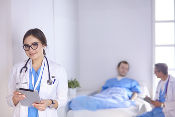 Doctor checking heart beat of patient in bed with stethoscope