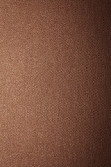 Brown-golden texture with gradient, background, abstraction. Space for text. Matte coating