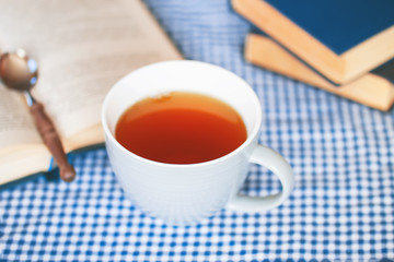 a cup of green tea and a book on the table close-up. the concept of relaxing while drinking tea and reading books.