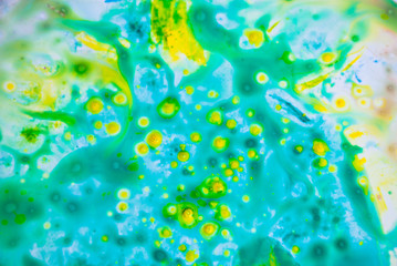 Naklejka na ściany i meble Fluid art acrylic party background. Cosmic music poster. Creative artwork hippie wallpaper in yellow and green color.