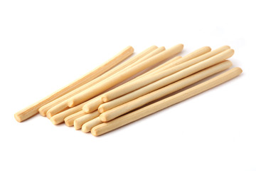 Bread sticks isolated on white background. Pile of crunchy bread sticks.