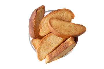 Wheat rusks isolated on white background. Pile of crispy dry bread slices top view.