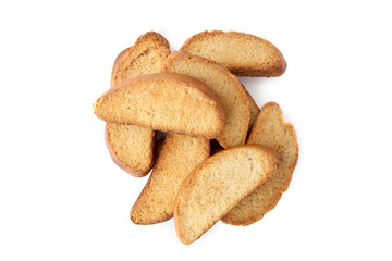 Wheat rusks isolated on white background. Pile of crispy dry bread slices top view.
