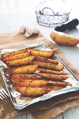Baked potato wedges on tray - homemade wedges snack. Healthy lifestyle