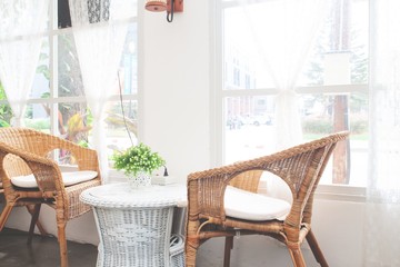 Vintage style furniture made from rattan in cafe. Decorated in white color tone