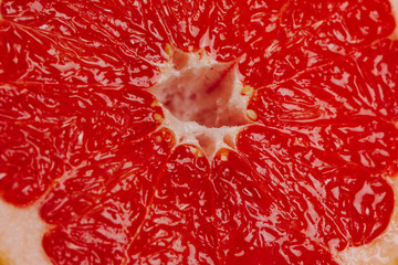 Pink ripe grapefruit slice on white isolated background
