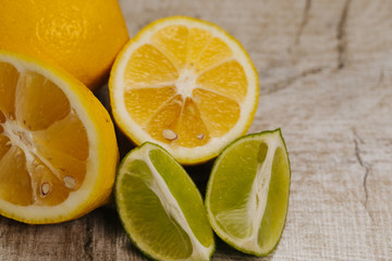 half of lime and lemon on  wood background