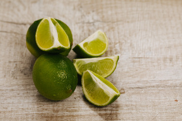 fresh green lime on wooden background