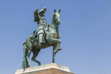 Fototapeta na wymiar VERSAILLES / FRANCE - JULY 2015: Bronze statue of Louis XIV in Versailles, France