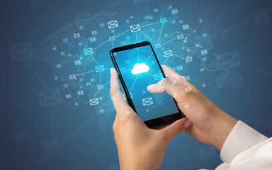 Female hand using smartphone with cloud, message and global concept

