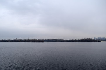 Fabulous landscape of the river and the dark dry forest. Evening.