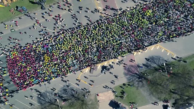Aerial view from drone on crowd of people who is starting their run on marathon event.