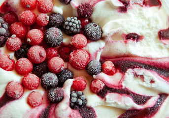 Close up of ice cream with forest frozen berries. Summer food dessert top.