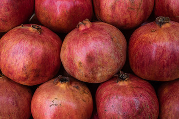 Ripe, natural garnet. It is a lot of garnet fruits on a market show-window
