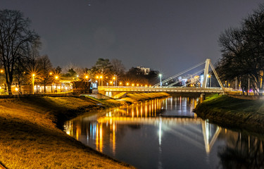 Fototapeta premium Illuminated bridge over the river, Nitra, Slovakia, night