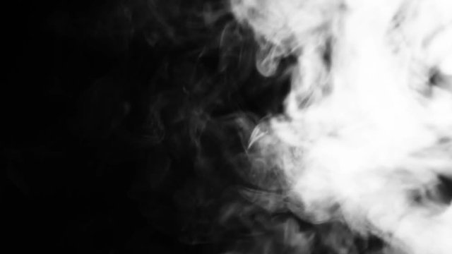 Dynamic smoke motion on a dark black background for video design