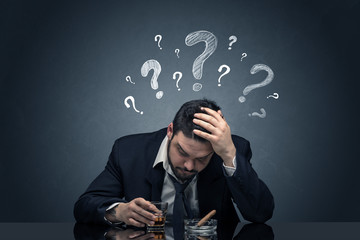 Young drunk disappointed man with question signs concept
