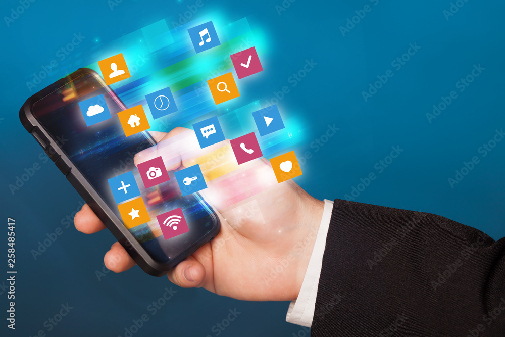 Aufkleber hand using phone with colorful fast moving application icons and symbols concept