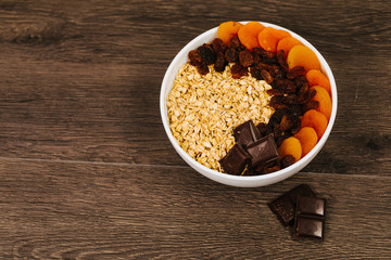 Bowl of oatmeal porridge with chocolate and caramel sauce