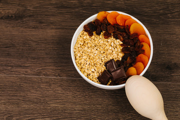 Bowl of oatmeal porridge with chocolate and caramel sauce