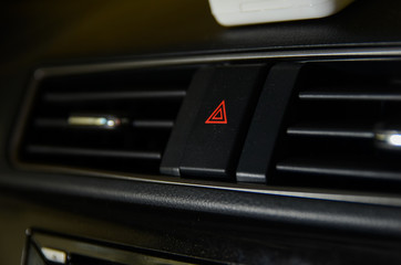 Fototapeta na wymiar Emergency button close up macro shot on Malaysian car dashboard.