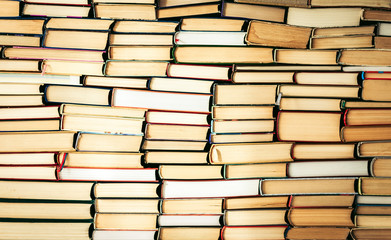 Stack of books education concept background, many books piles with copy space for text.