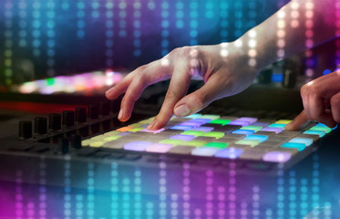 Fototapeta premium Hand mixing music on dj controller with social media concept icons 