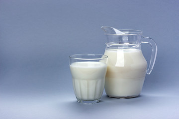 Jar and glass of milk isolated on white background with copy space for text, dairy product concept