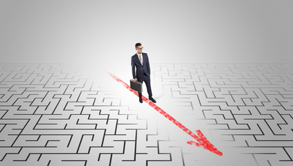 Businessman going through the maze with red arrow
