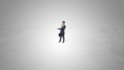 Young businessman standing alone in the middle of an empty space
